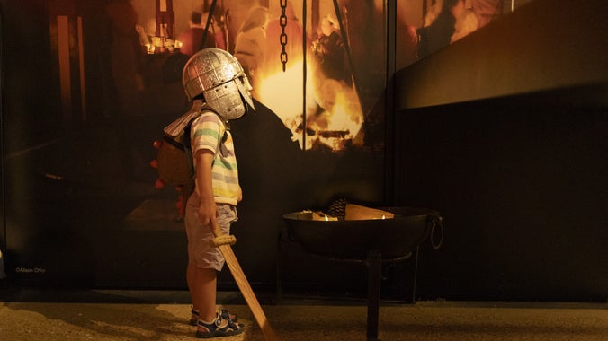 A young boy dresses up as an Anglo-Saxon warrior in the exhibition space at Sutton Hoo